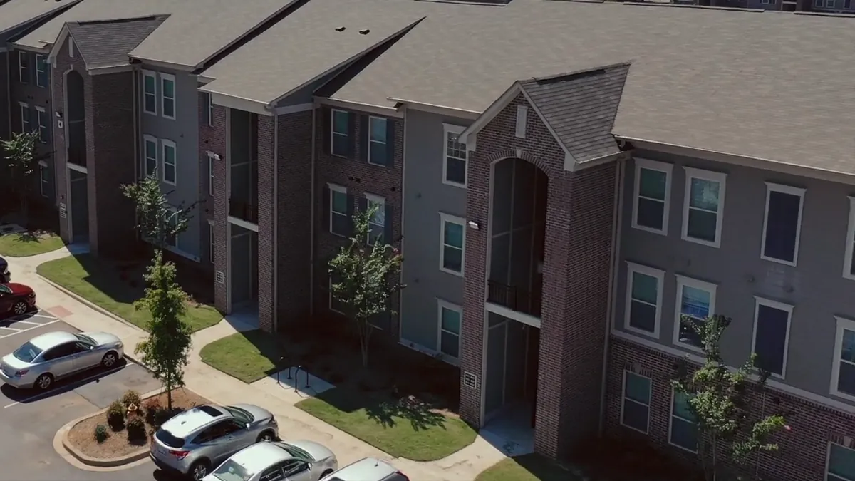 Brick and siding of a three-story apartment building