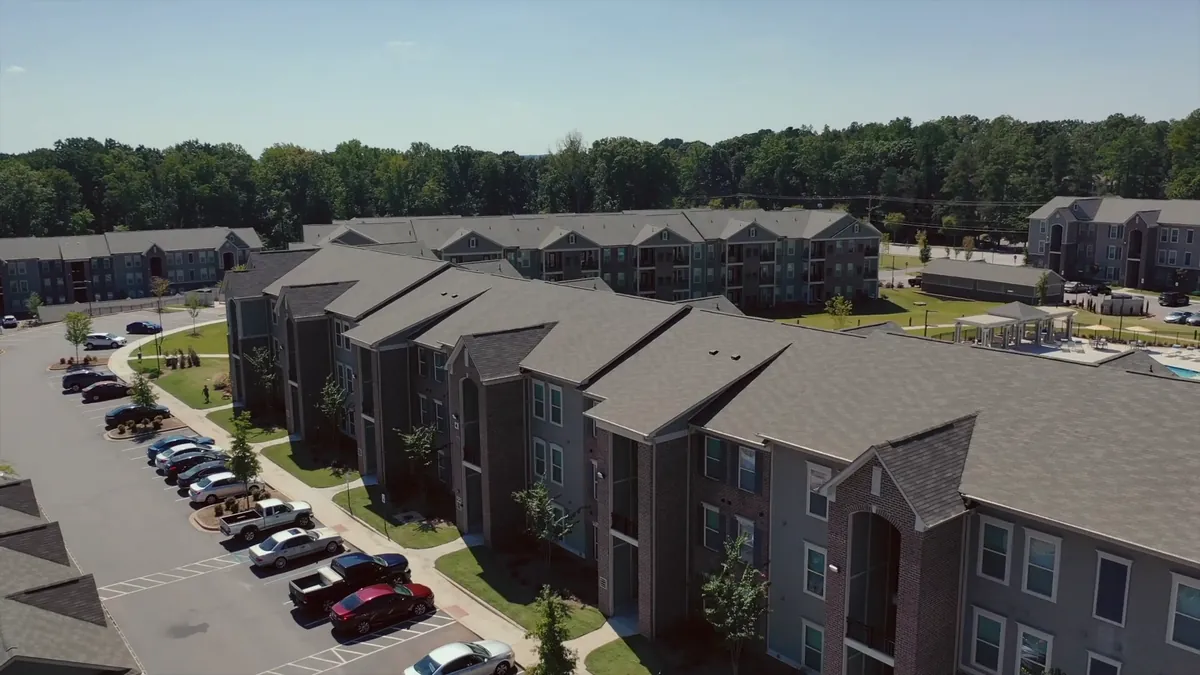 Aerial view of an apartment community and its parking lot