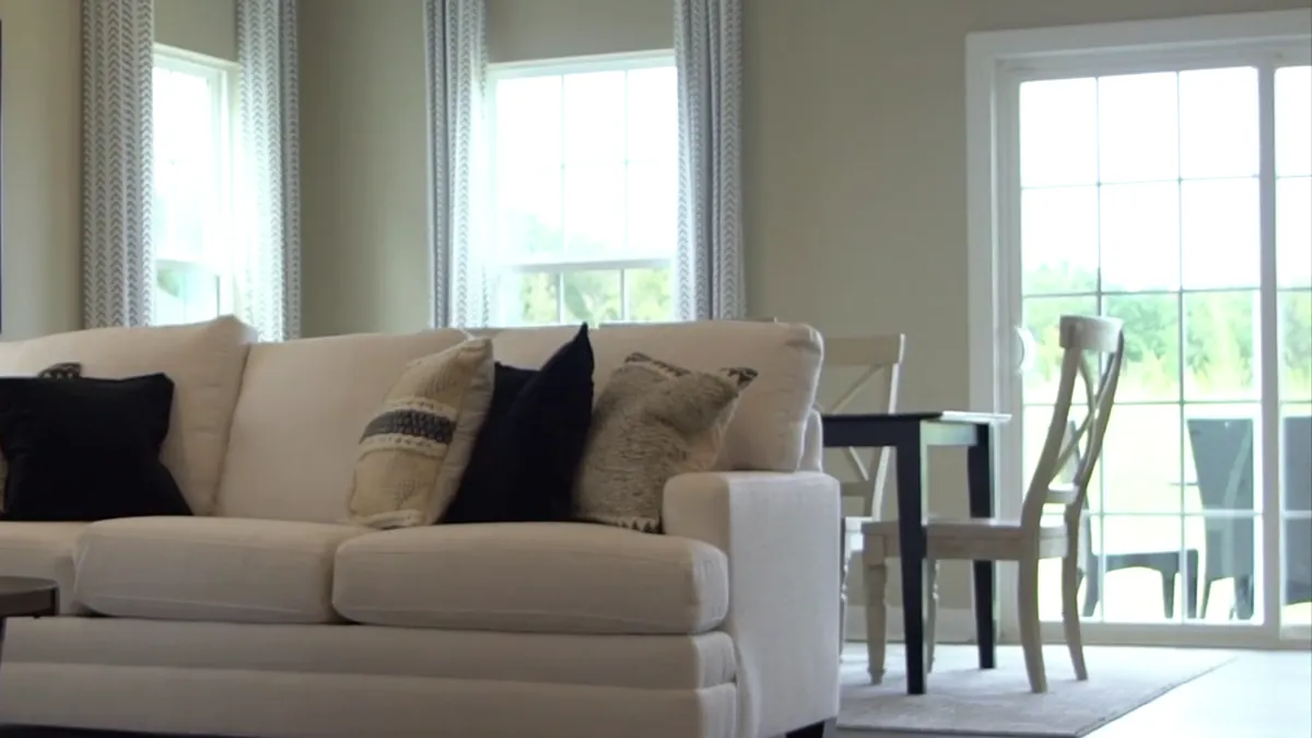 Dining chairs by a sliding door in a finished home