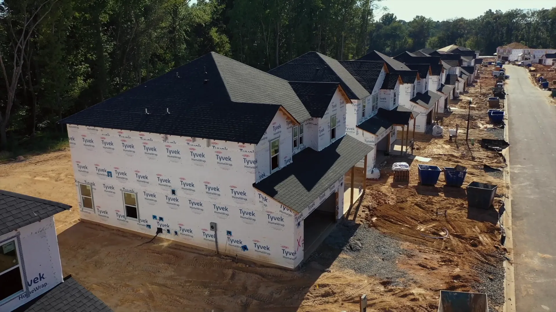 New home in house wrap on an active jobsite street