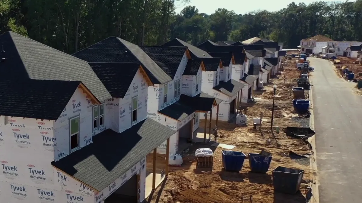 A street of new homes in house wrap during construction