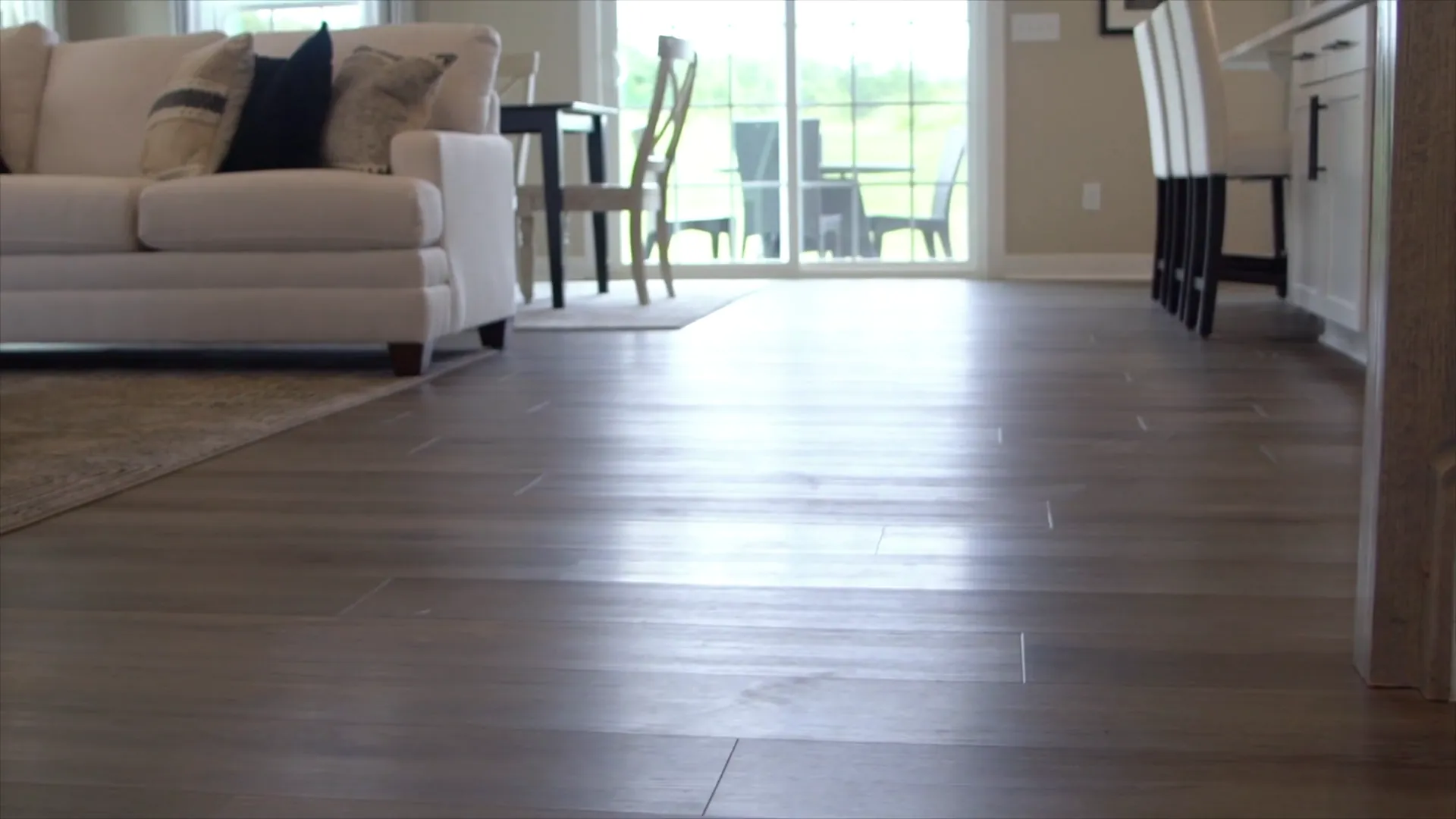 Floor-level view across a finished plank floor