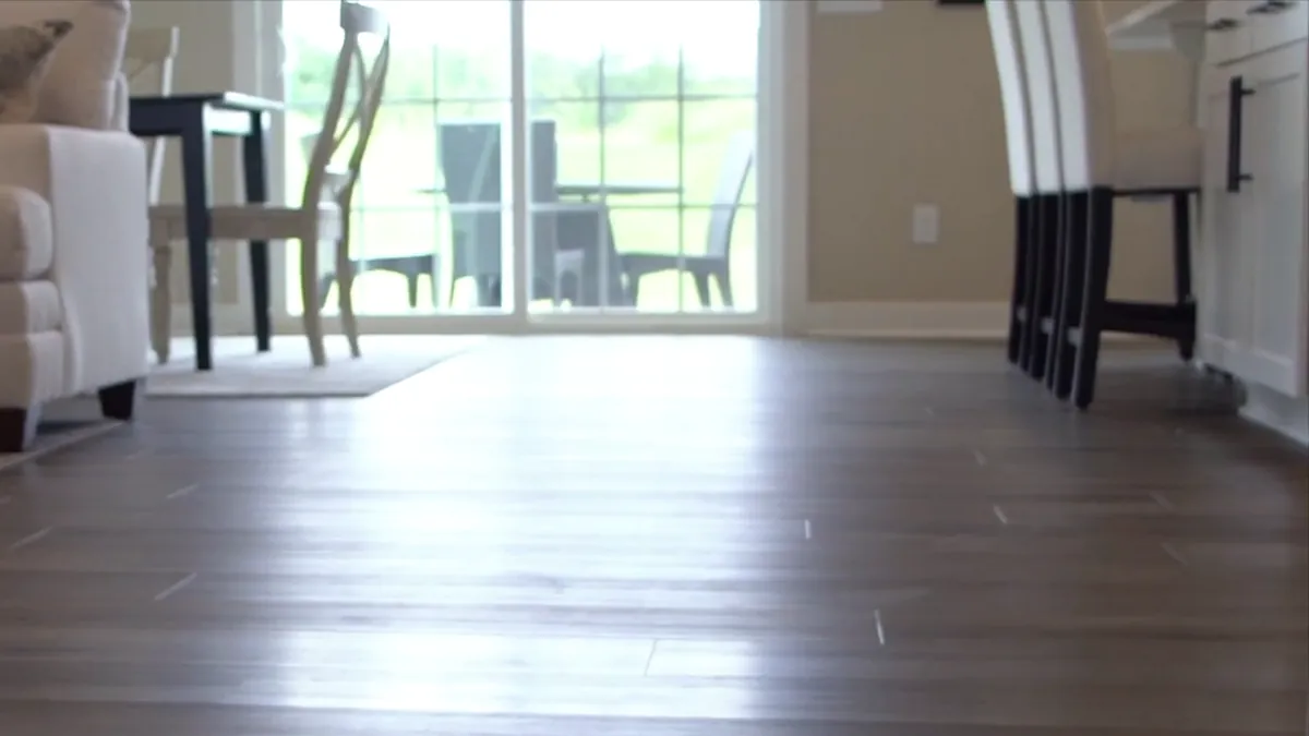 Window light across a plank floor at the kitchen edge