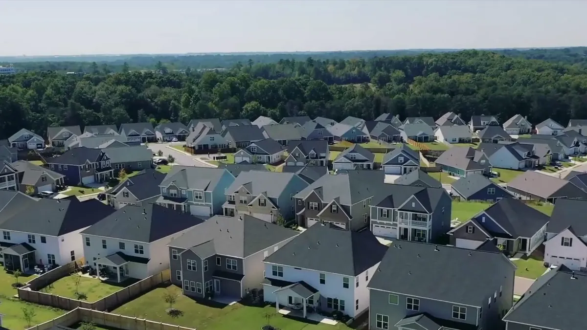 Rows of finished homes running to the tree line
