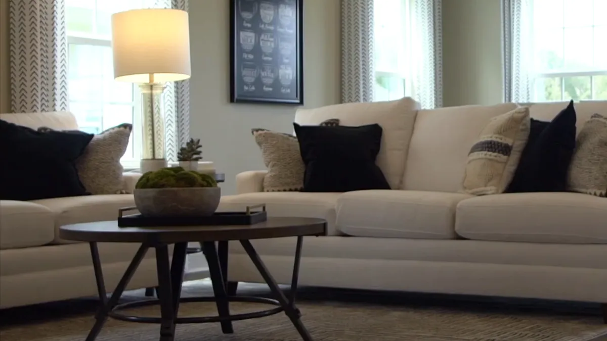 Sofa and lamp in a living room finished with plank flooring