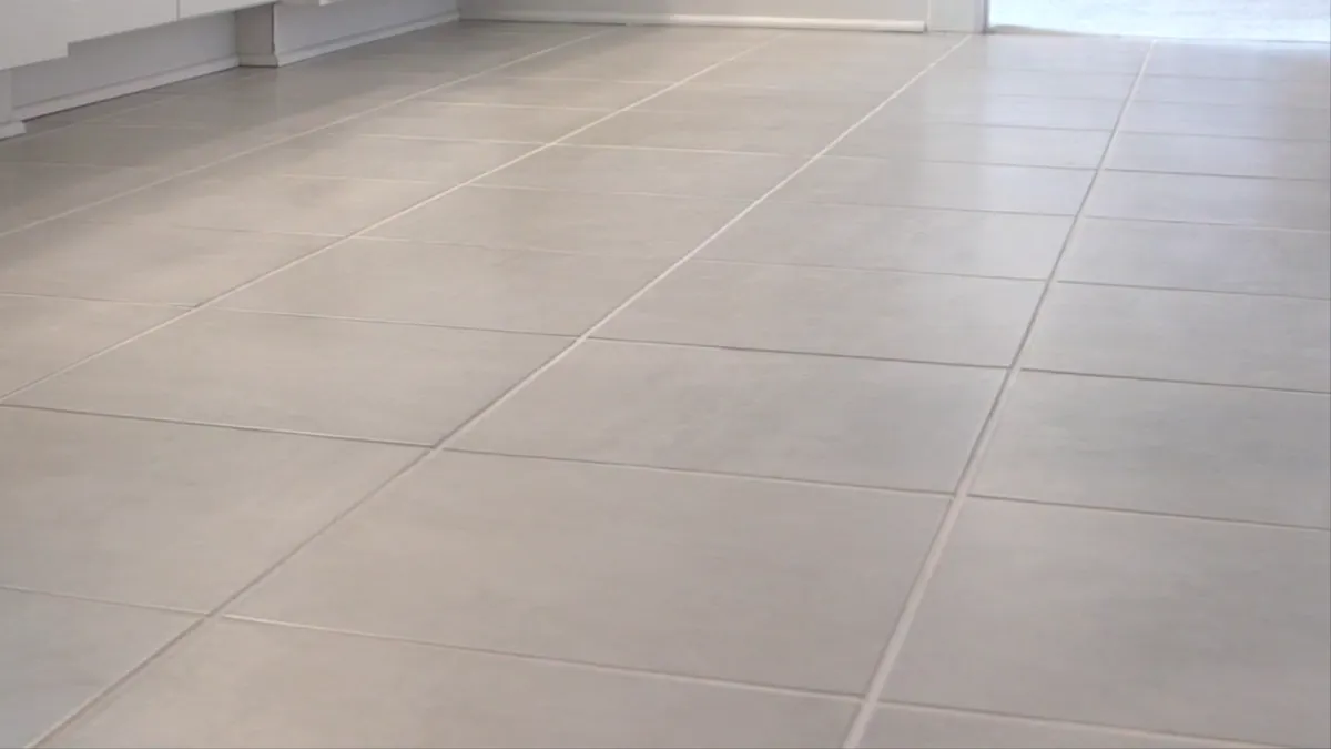 A light tile floor running through a finished kitchen