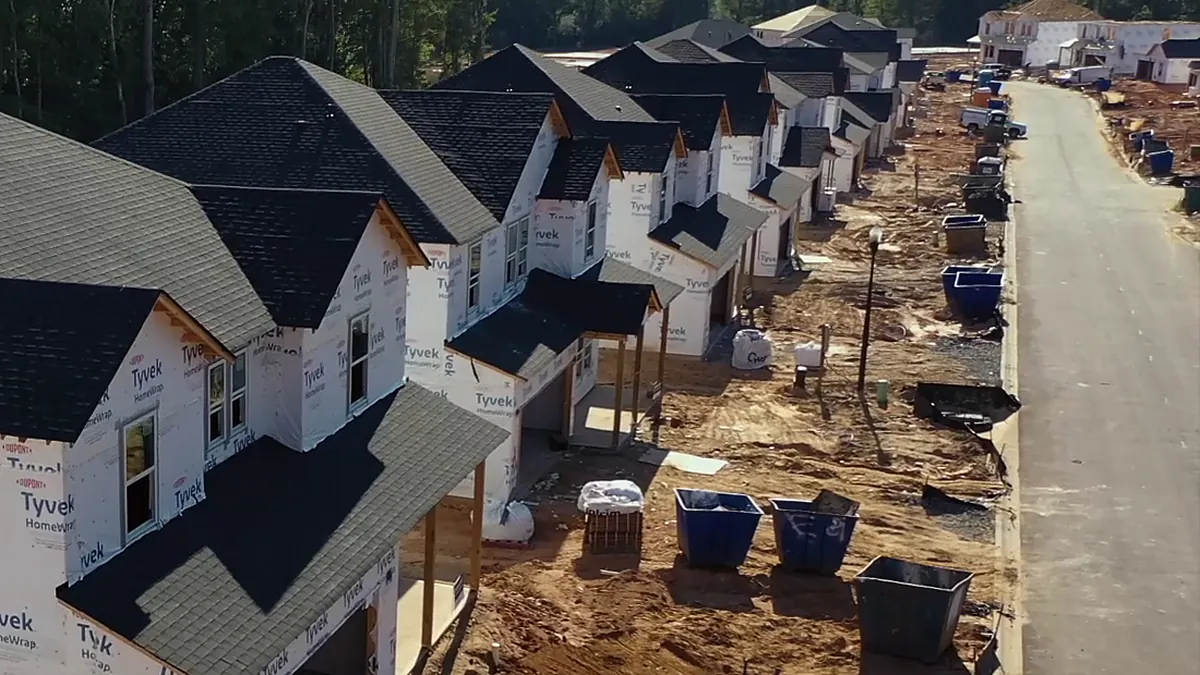 A street of new homes in house wrap during construction